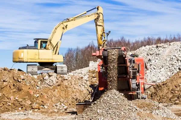 excavator and rock crusher at a construction site