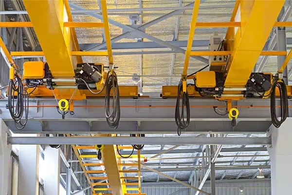 yellow overhead crane in a large warehouse