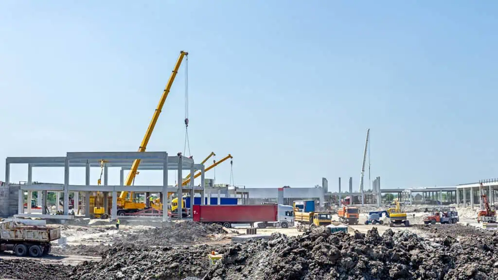 panoramic view of a construction site with mobile equipment and cranes