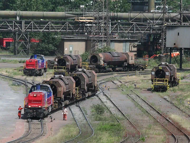 outside overhead view of a railyard with locomotives switching tracks