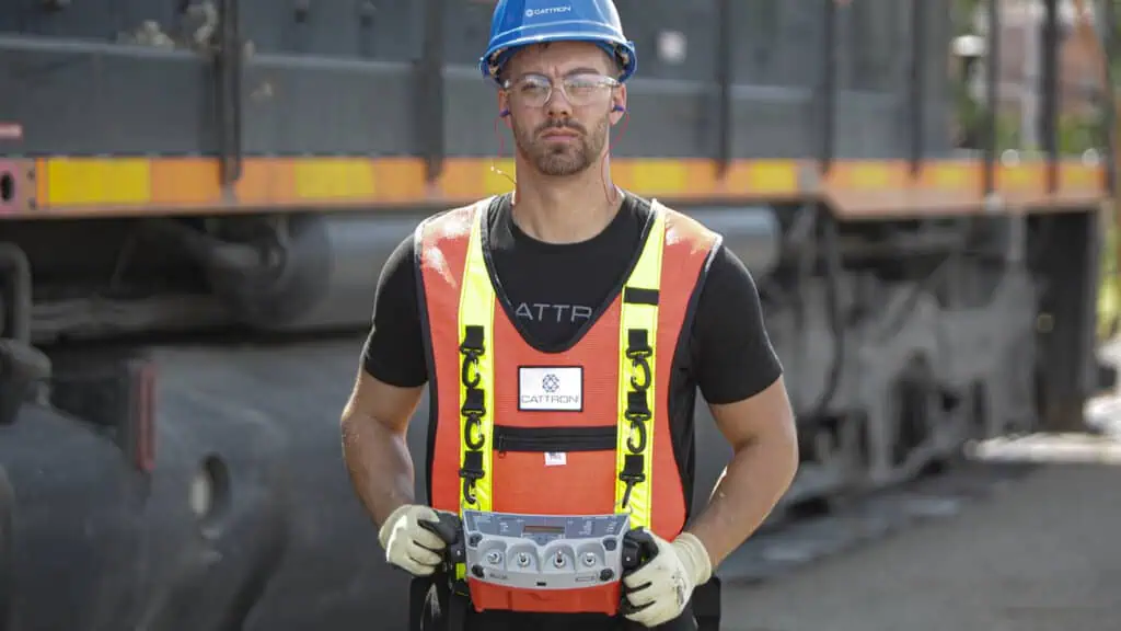 rail yard operator wearing hard hat and locmotive operator control unit